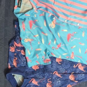 One navy flamingo polo, one blue and pink flamingo button down.